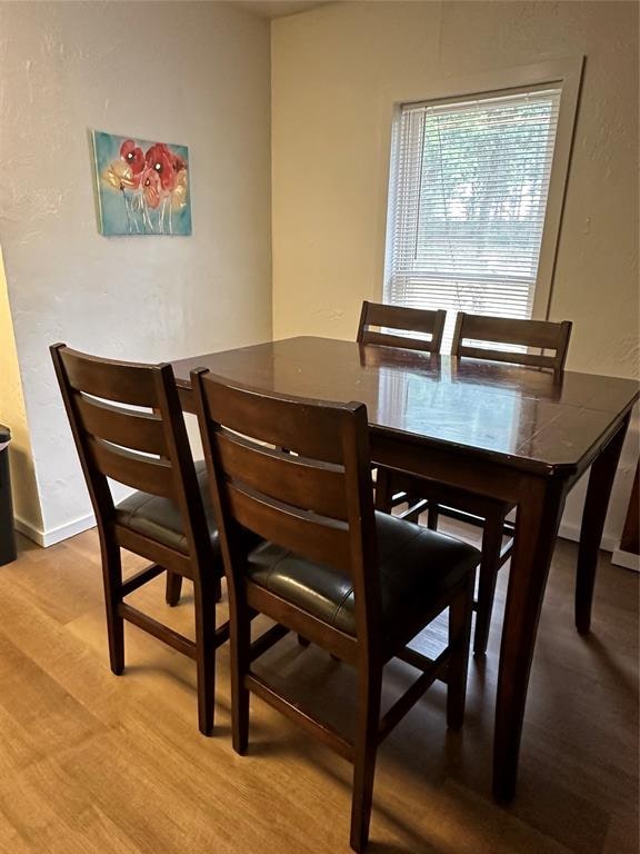 dining room with wood-type flooring