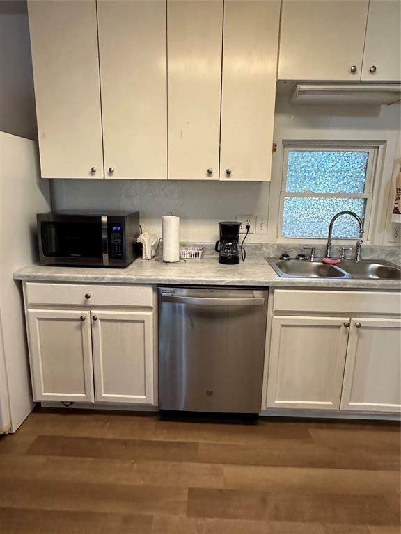 kitchen with dark hardwood / wood-style flooring, sink, white cabinetry, and stainless steel appliances