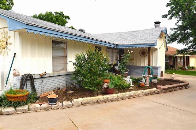 5932 NW 62nd Ter, Oklahoma City, OK 73122 - view of front of home featuring a chimney and roof with shingles