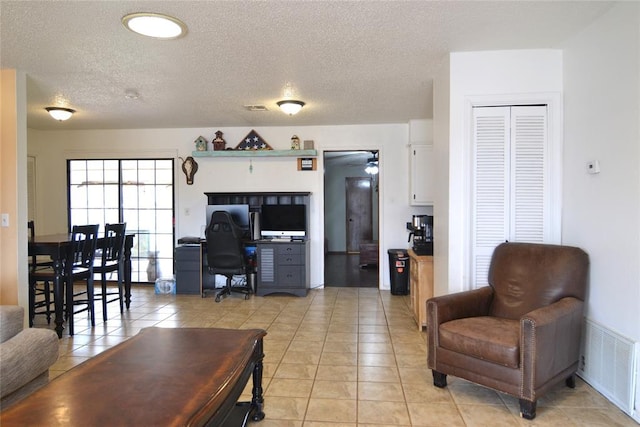 5932 NW 62nd Ter, Oklahoma City, OK 73122 - living room with an office area, light tile patterned floors, a textured ceiling, and a ceiling fan