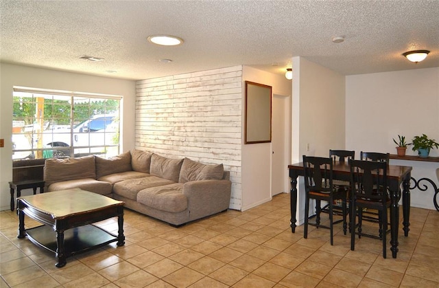 5932 NW 62nd Ter, Oklahoma City, OK 73122 - living room featuring a textured ceiling and light tile patterned flooring