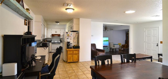 5932 NW 62nd Ter, Oklahoma City, OK 73122 - dining space featuring a ceiling fan, a textured ceiling, and light tile patterned floors