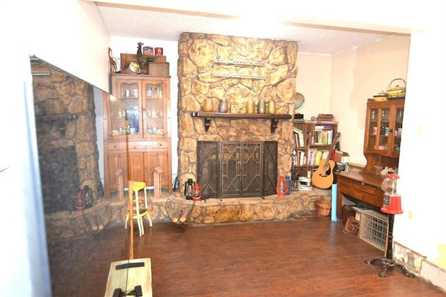 5932 NW 62nd Ter, Oklahoma City, OK 73122 - living room featuring a fireplace, a textured ceiling, and wood finished floors