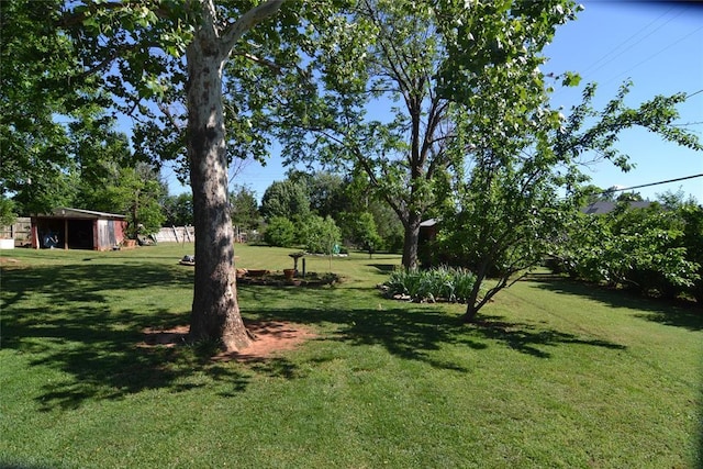 5932 NW 62nd Ter, Oklahoma City, OK 73122 - view of grassy yard featuring an outdoor structure
