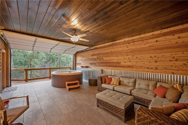 interior space with an outdoor hangout area, a hot tub, and ceiling fan