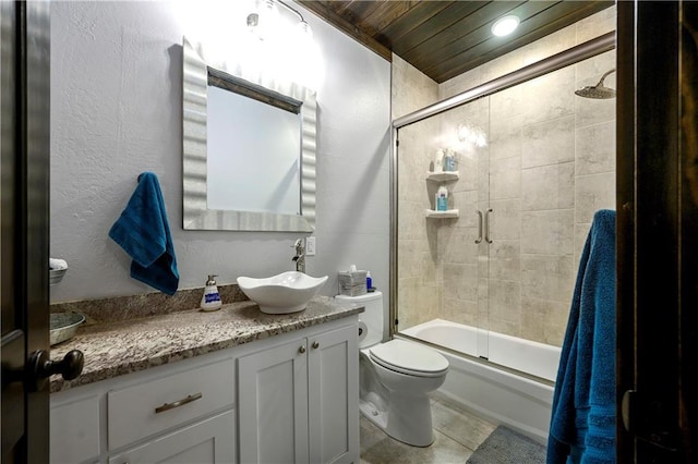 full bathroom featuring tile patterned floors, vanity, wooden ceiling, enclosed tub / shower combo, and toilet