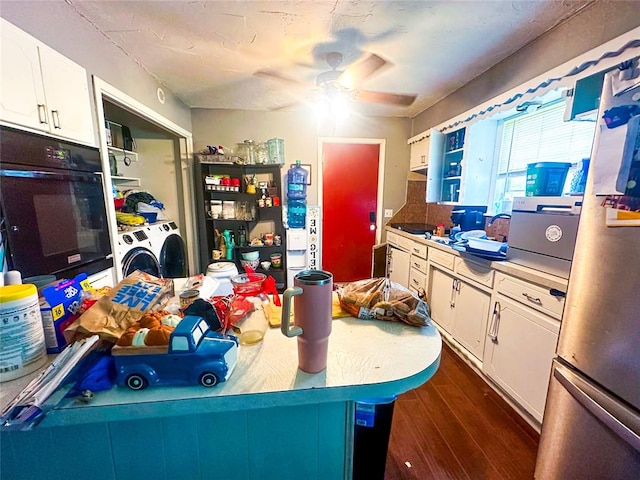 kitchen with white cabinetry, ceiling fan, separate washer and dryer, dark hardwood / wood-style floors, and oven