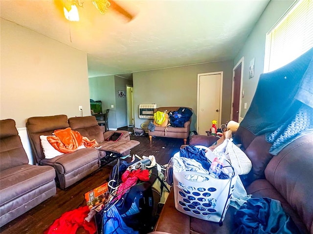 living room with hardwood / wood-style flooring, heating unit, and ceiling fan