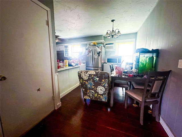 dining area featuring a chandelier and dark hardwood / wood-style floors