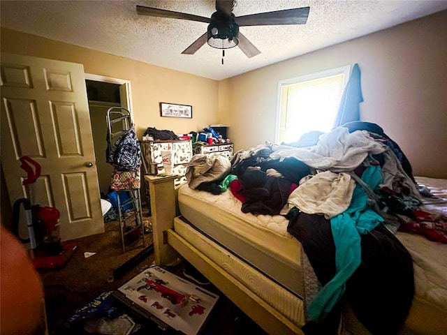 bedroom with dark colored carpet, ceiling fan, and a textured ceiling