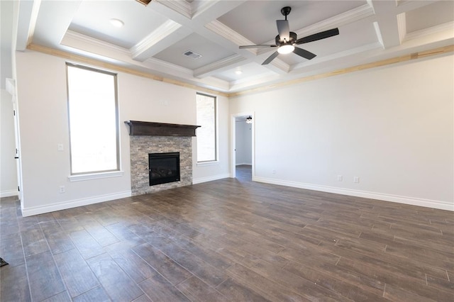 unfurnished living room featuring ceiling fan, coffered ceiling, and plenty of natural light