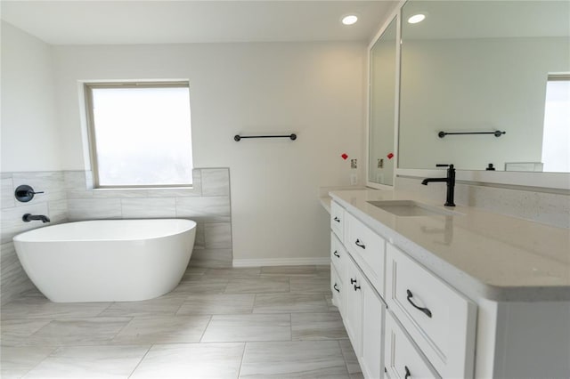 bathroom with vanity and a bathtub