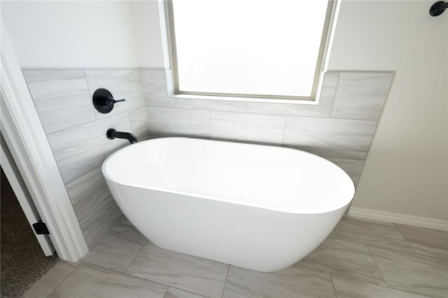 bathroom with a tub to relax in