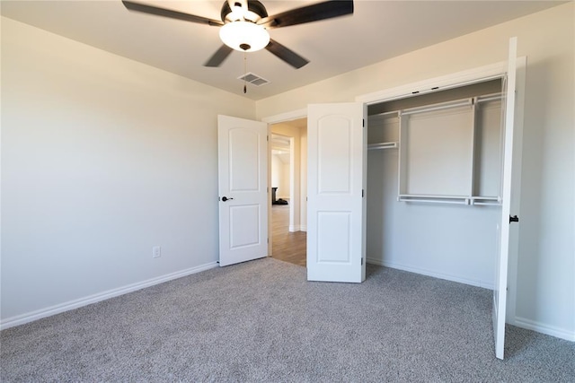 unfurnished bedroom with ceiling fan, a closet, and carpet floors