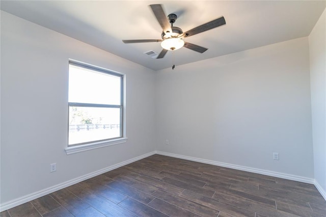 spare room with dark wood-type flooring and ceiling fan