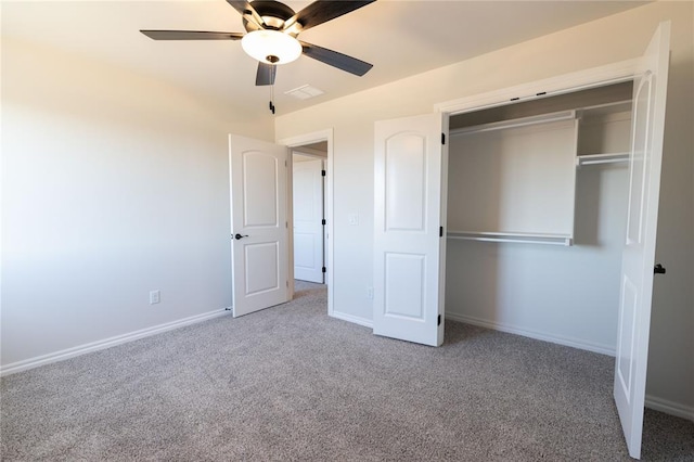 unfurnished bedroom with ceiling fan, a closet, and carpet floors