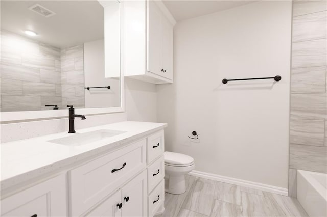 bathroom featuring toilet and vanity