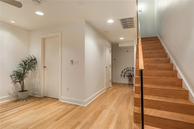 stairway with hardwood / wood-style floors