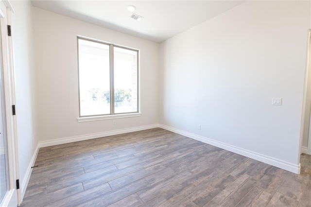 spare room featuring dark hardwood / wood-style flooring