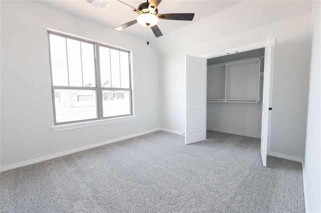 unfurnished bedroom featuring vaulted ceiling, ceiling fan, carpet floors, and a closet