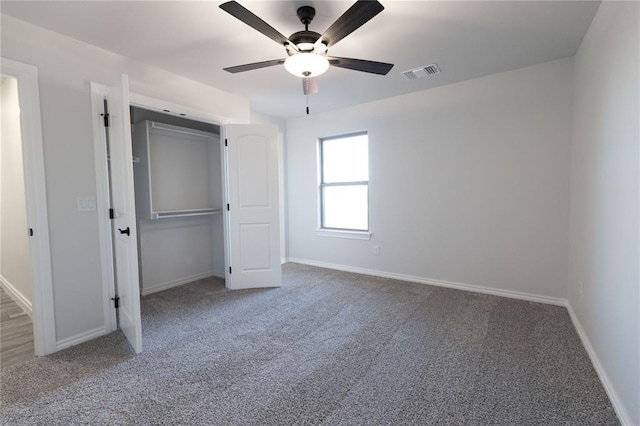 unfurnished bedroom featuring ceiling fan, carpet flooring, and a closet