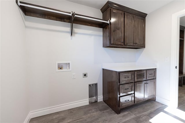 washroom featuring hookup for a washing machine, dark hardwood / wood-style flooring, electric dryer hookup, and cabinets