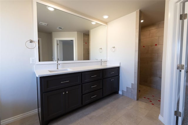 bathroom featuring vanity and tiled shower