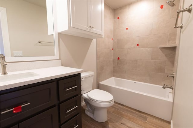 full bathroom featuring toilet, vanity, and tiled shower / bath combo