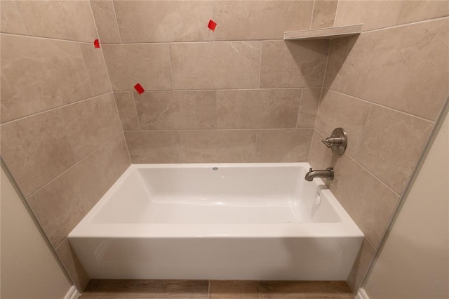 bathroom with bathing tub / shower combination