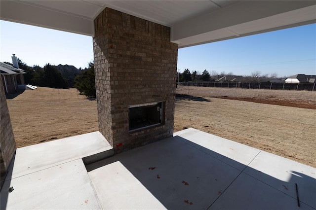 view of patio / terrace with an outdoor brick fireplace