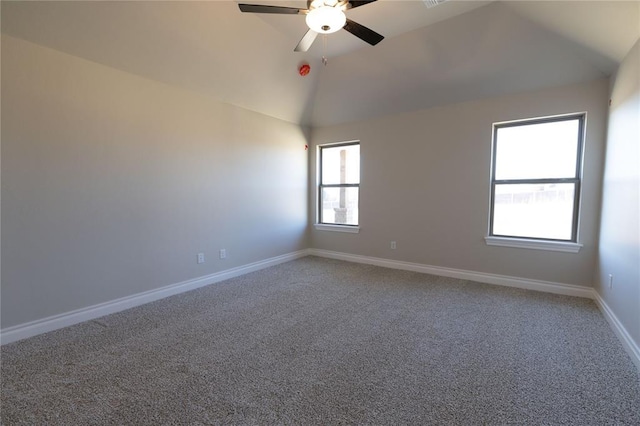 carpeted empty room with ceiling fan and vaulted ceiling