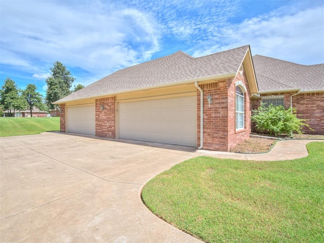 view of front of house with a front yard and a garage