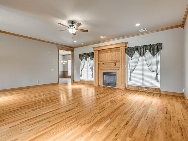 unfurnished living room with ceiling fan with notable chandelier, light wood-type flooring, and ornamental molding