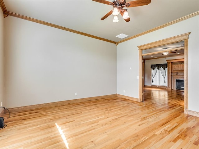 unfurnished living room with ceiling fan, light hardwood / wood-style floors, and ornamental molding