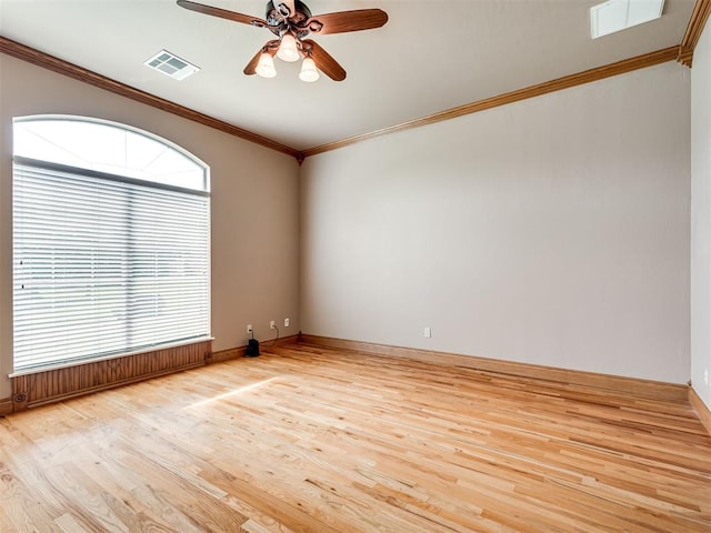 empty room featuring crown molding, light hardwood / wood-style flooring, and ceiling fan