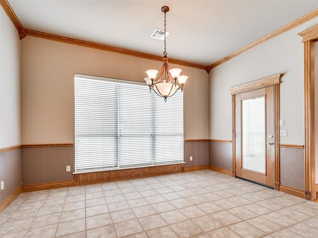 unfurnished dining area featuring plenty of natural light, crown molding, and an inviting chandelier