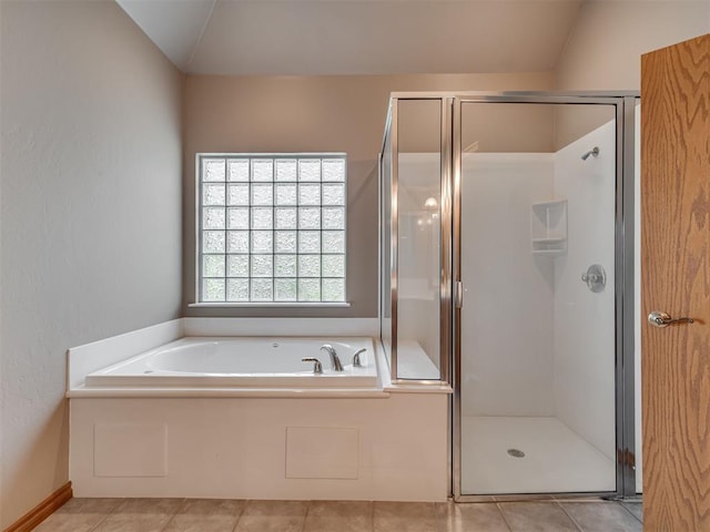 bathroom featuring tile patterned flooring, independent shower and bath, and vaulted ceiling