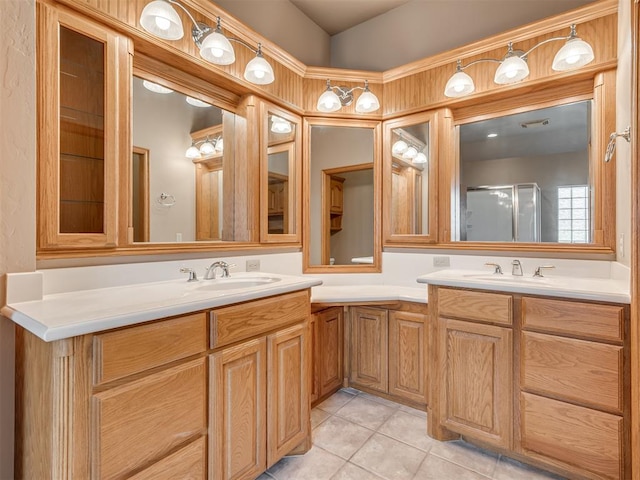 bathroom featuring tile patterned flooring, vanity, and walk in shower