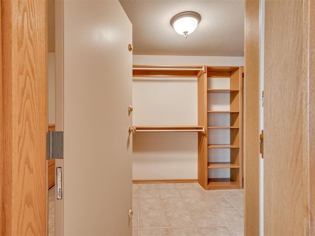 walk in closet featuring light tile patterned floors