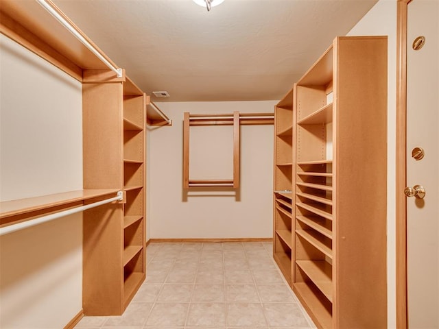 walk in closet featuring light tile patterned floors