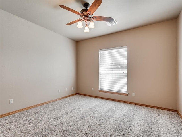 carpeted spare room featuring ceiling fan