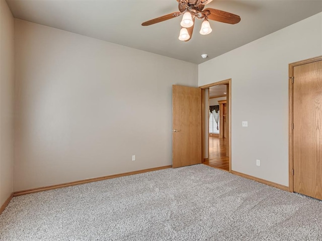 carpeted empty room with ceiling fan