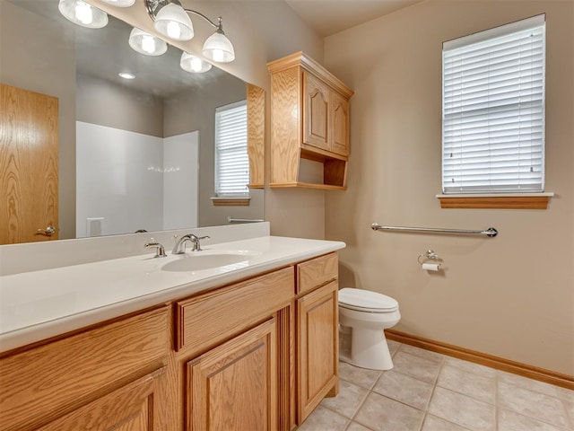 bathroom featuring tile patterned flooring, vanity, and toilet