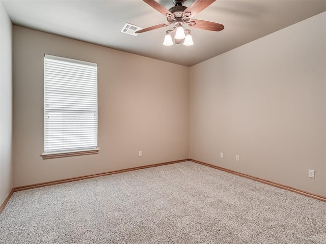 carpeted empty room featuring ceiling fan