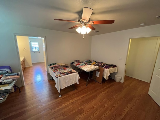 bedroom with ceiling fan and dark wood-type flooring