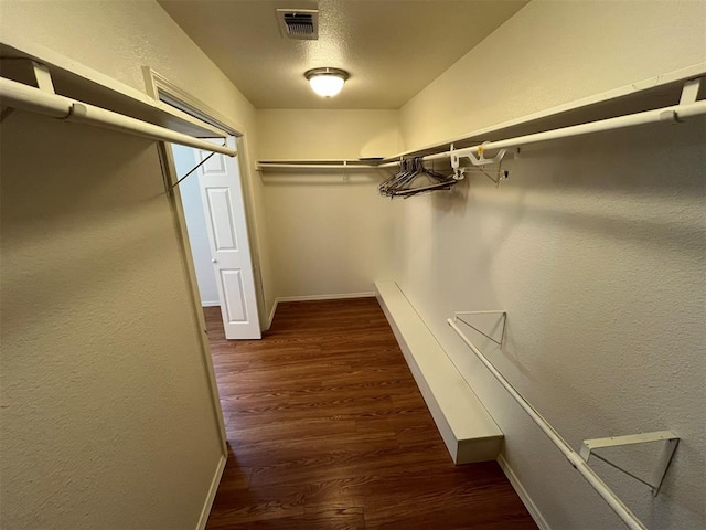 spacious closet with dark hardwood / wood-style floors