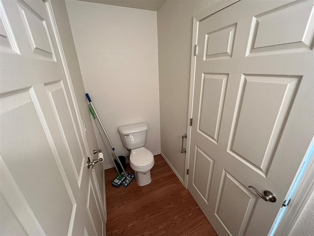 bathroom featuring hardwood / wood-style floors and toilet