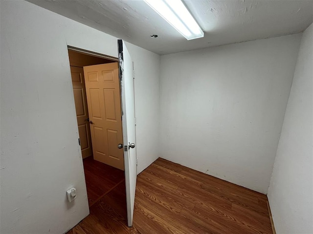 empty room with dark wood-type flooring