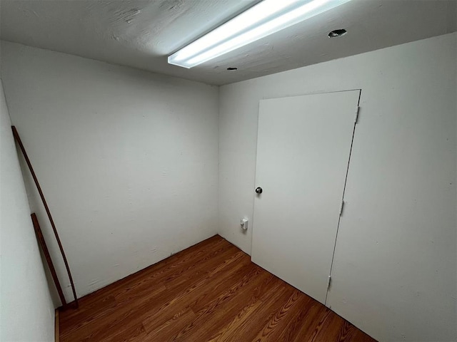 empty room with hardwood / wood-style flooring