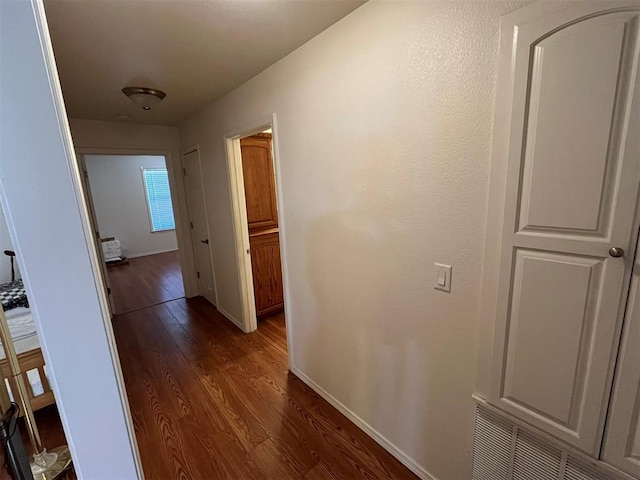 corridor featuring dark hardwood / wood-style floors